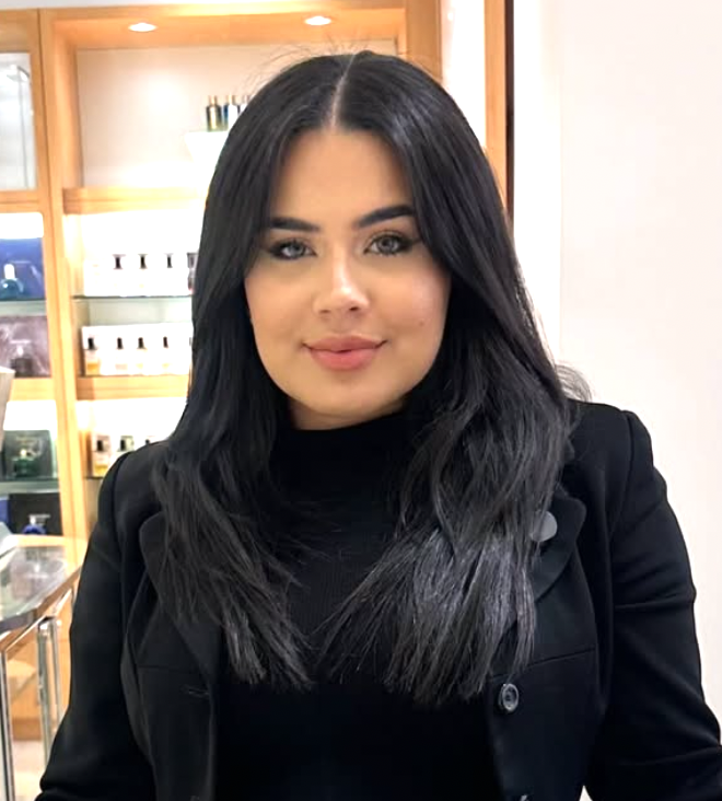 Val wearing a black blazer in a fragrance boutique